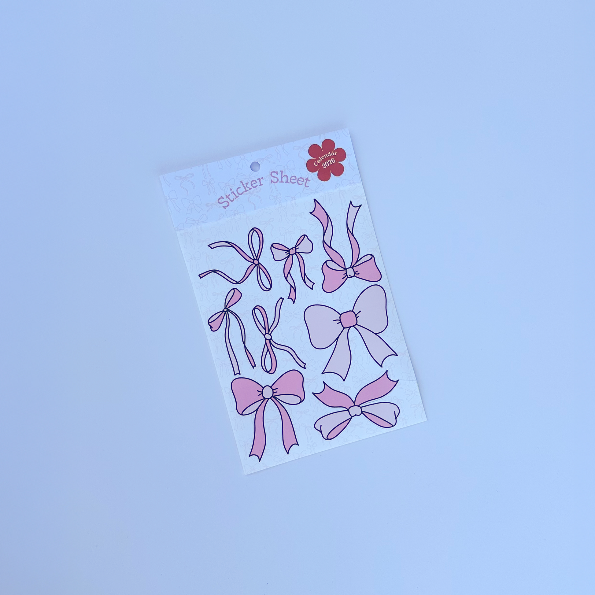 Sheet of pink bow stickers on a white background