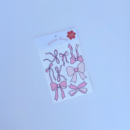 Sheet of pink bow stickers on a white background