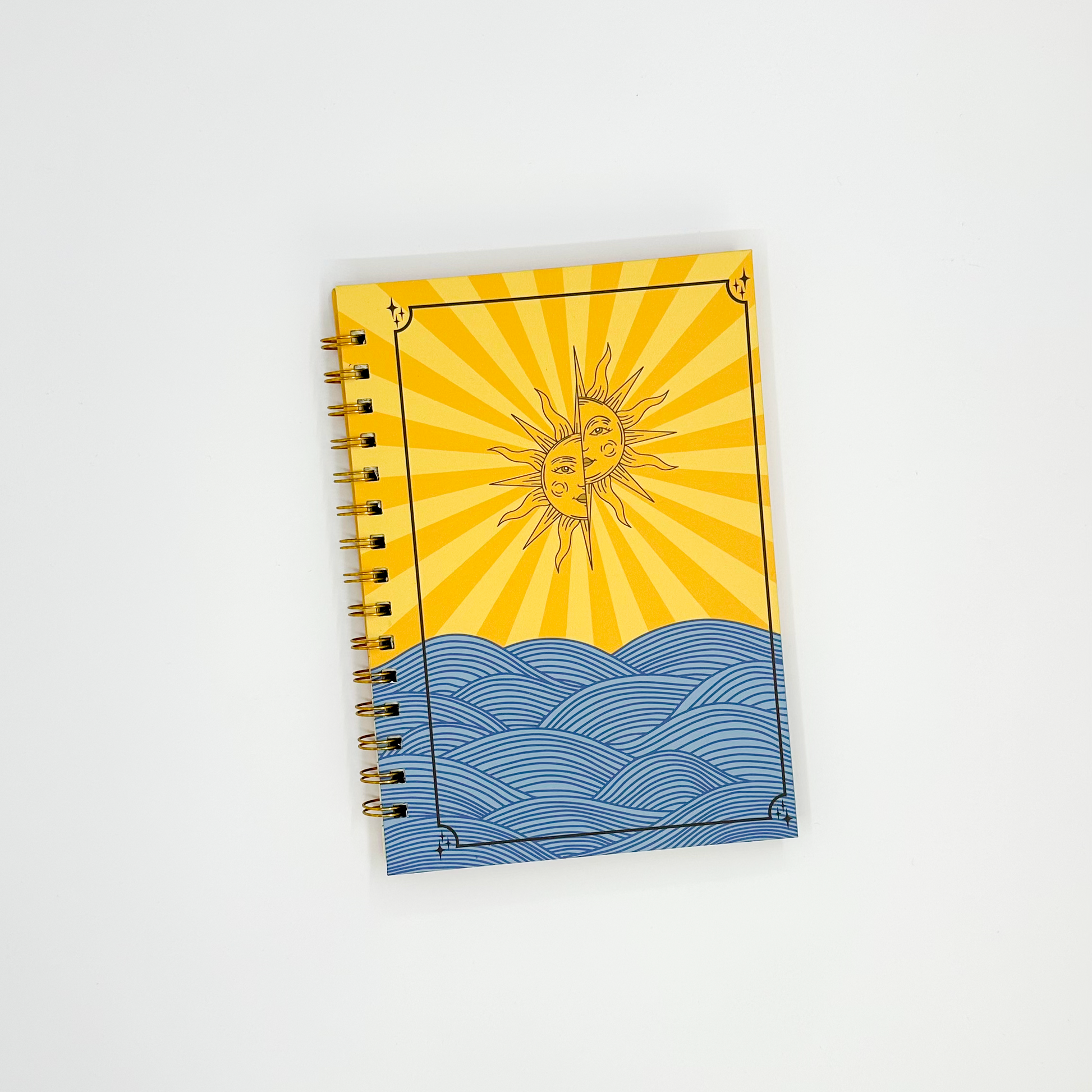 Notebook with sun and wave design on a white background