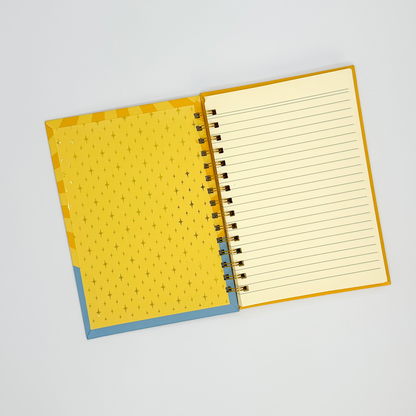 Open notebook with yellow cover and lined pages on a white background