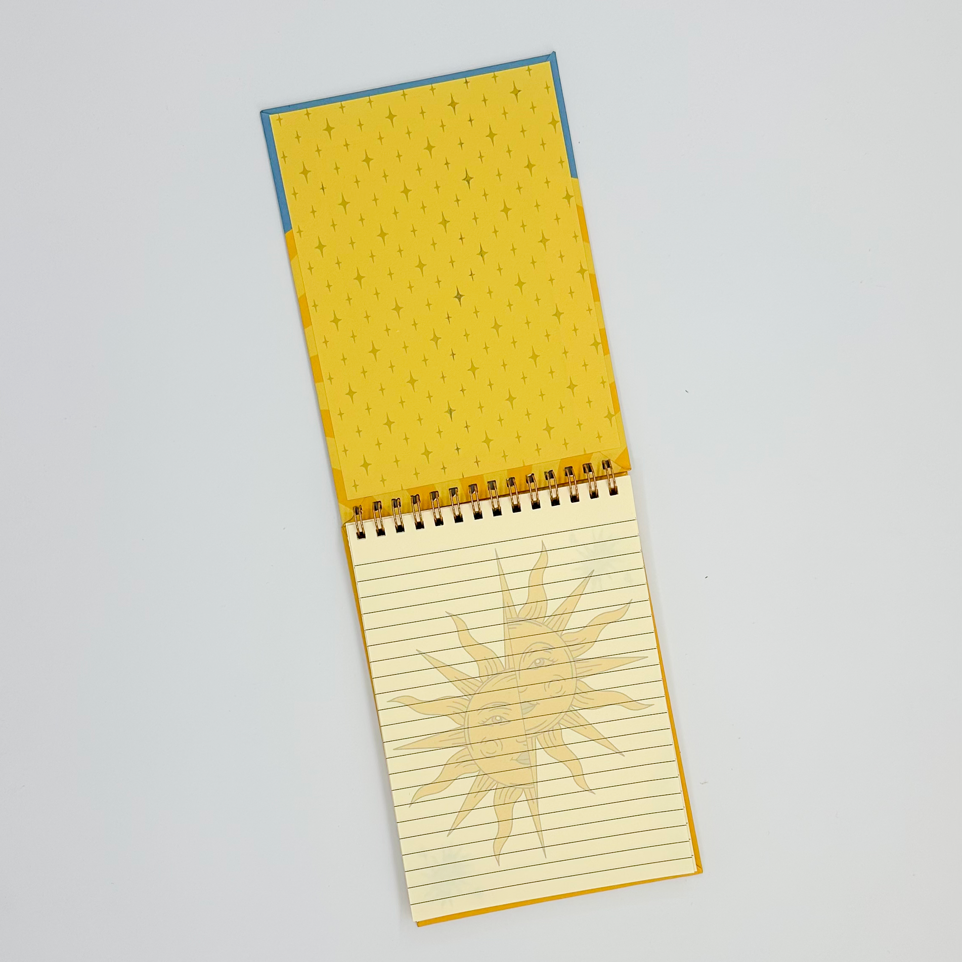 Yellow notepad inside cover with lined page on a white background
