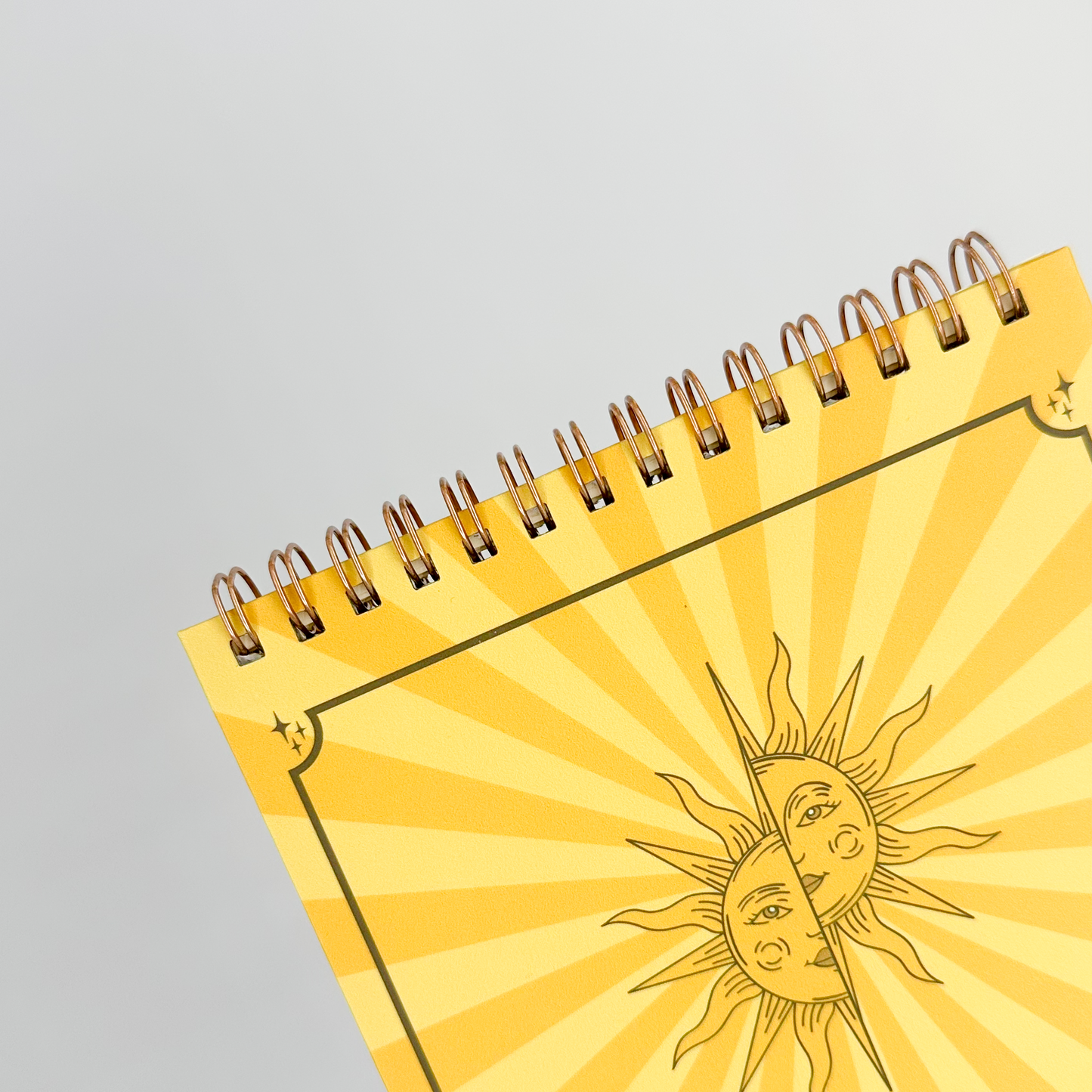 Yellow notebook with sun design on a white background