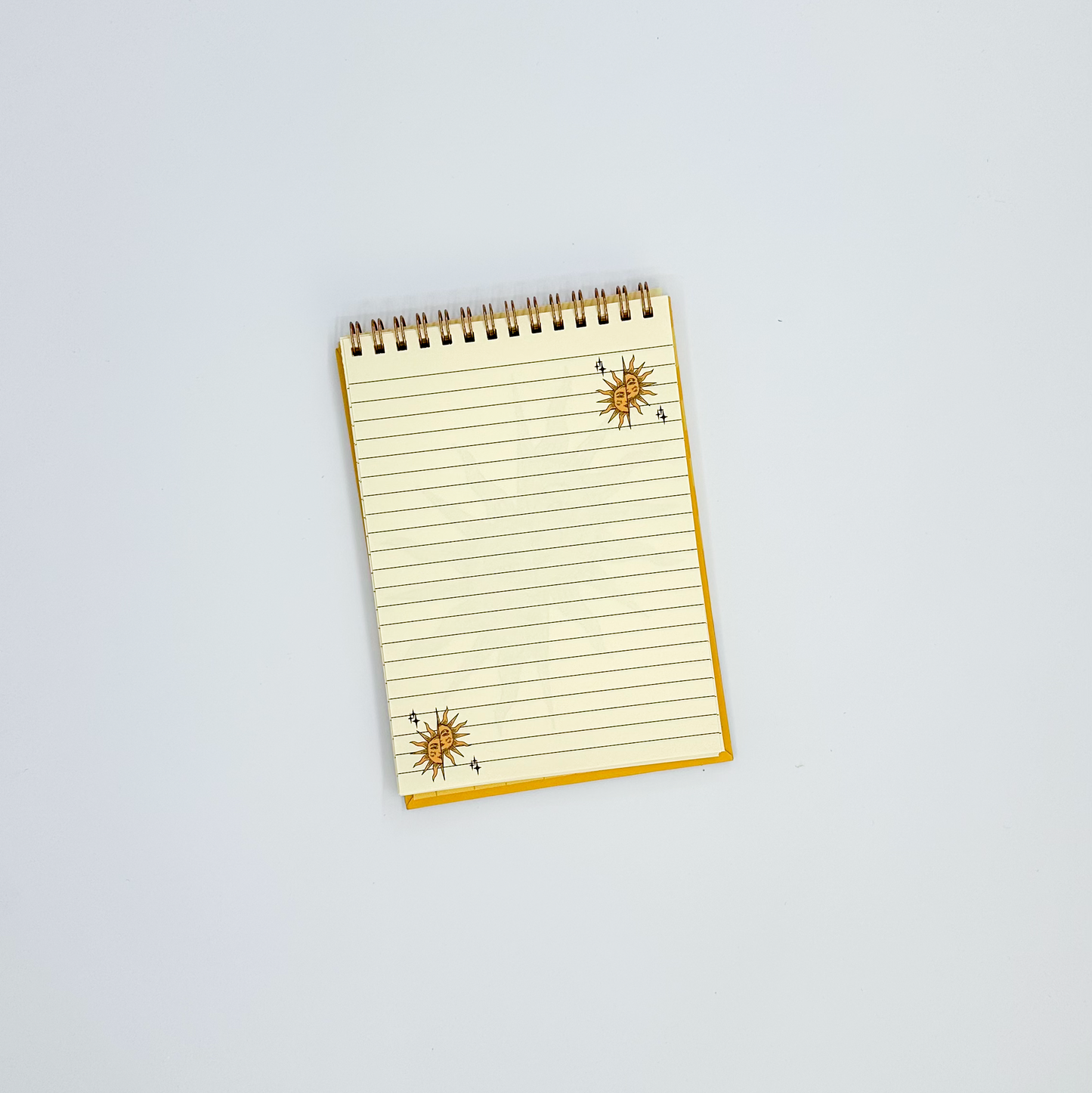 Notepad page with sun designs on a white background