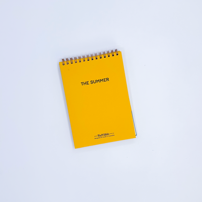 Yellow notepad back cover with 'THE SUMMER' text on a white background