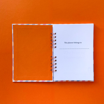 Open planner with orange cover in a orange background