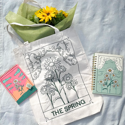 photo showing tote bag, notepad, notebook with sunflower