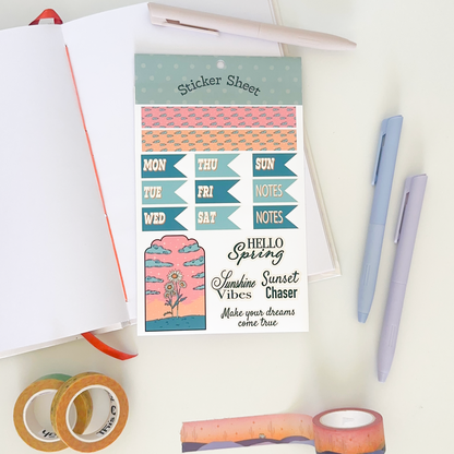 Sticker sheet with days of week with shades of green. background: notebook, pens and washi tapes