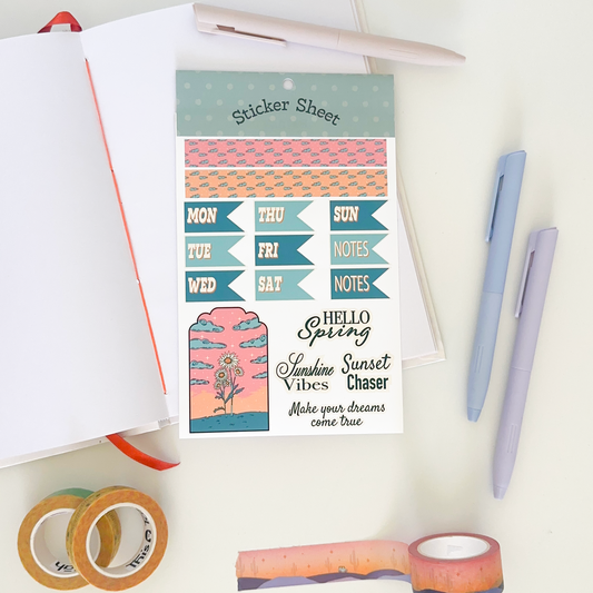 Sticker sheet with days of week with shades of green. background: notebook, pens and washi tapes