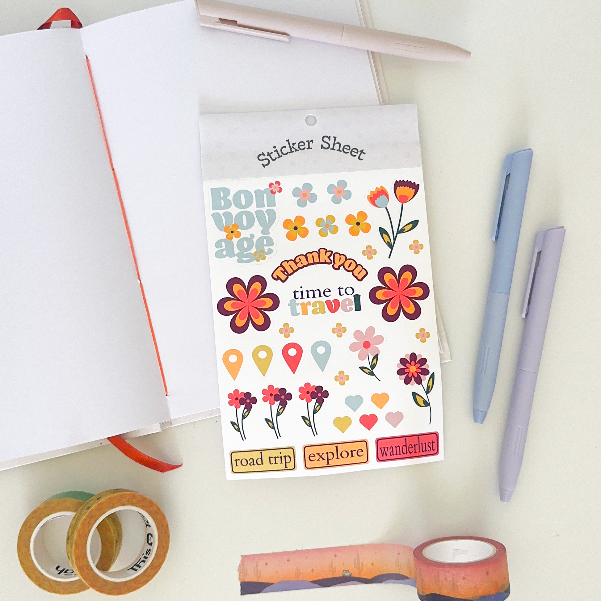Sticker sheet with flower themed with red and orange colours: notebook, pens and washi tapes