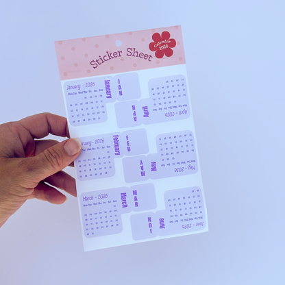 Hand holding a sticker sheet purple stickers on a white background